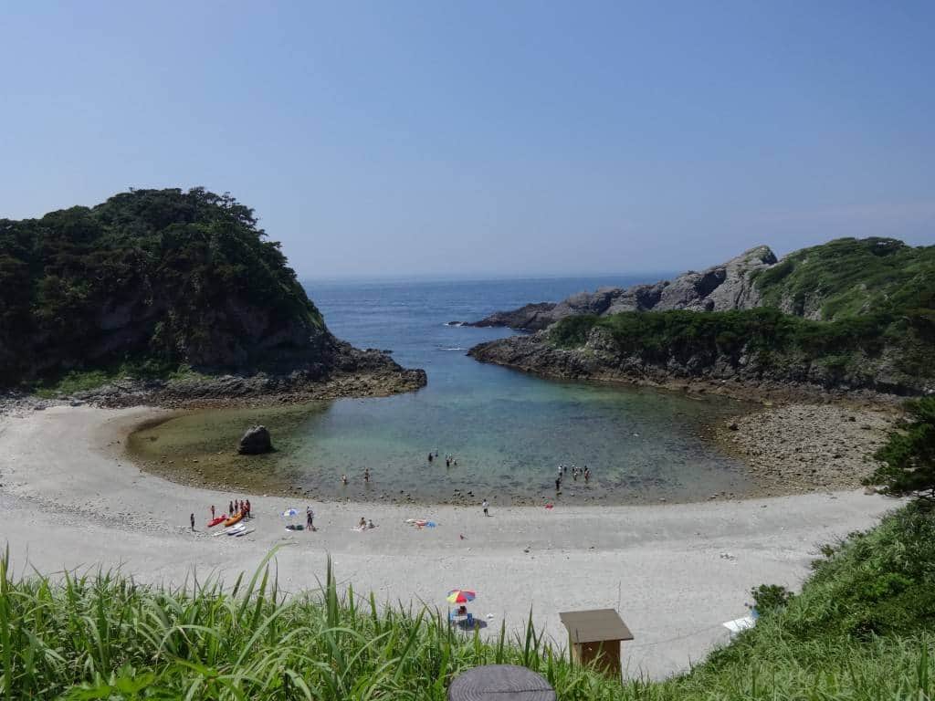 Featured in the travel posters adorning Tokyo's JR line, Tomari Beach looks sandier from a distance than it actually is. The tide-pool rimmed, rocky-bottomed shallow bowl is rich with fish, crabs, sea biscuits, and sea weed.
