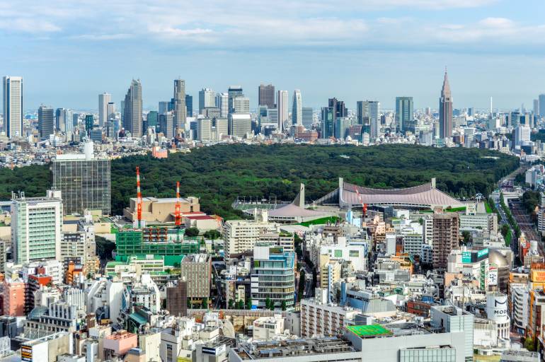 The tall buildings of Shinjuku with Yoyogi Park in the foreground.