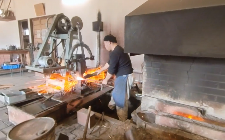 man forging a sword