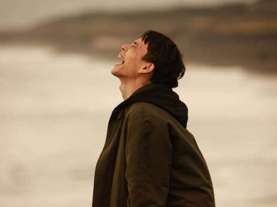 A man yelling at the sea