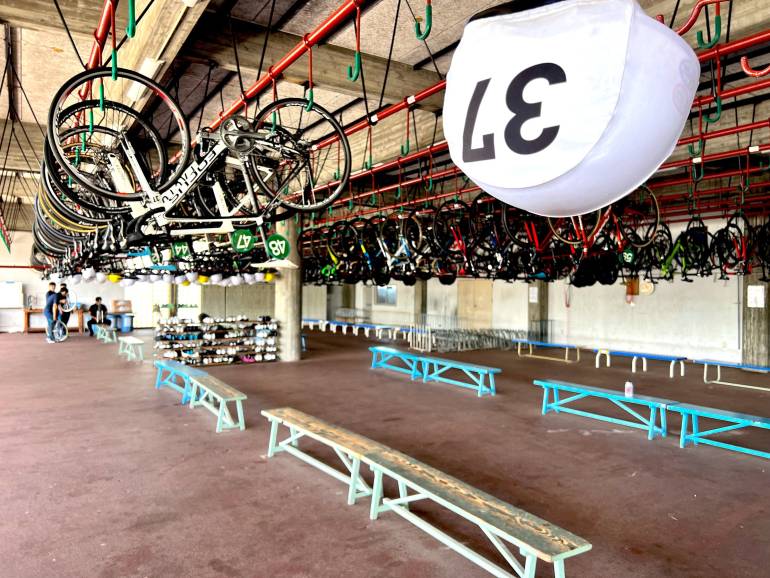 Rows of keirin bikes racked above the benches in the riders' quarters