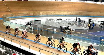 Keirin racers chase the pacer around the boards at the velodrome
