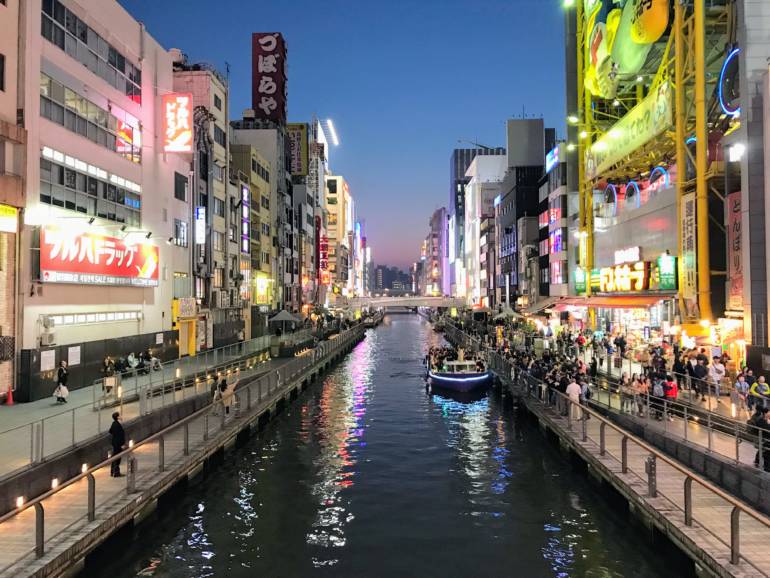 The busy Dotonbori Canal area at dusk