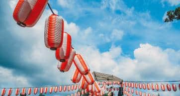 The stage of the Yagura with a big japanese taiko drum Odaiko. Paper red-white lanterns Chochin Scenery for the holiday Obon when people dance of Bon Odori