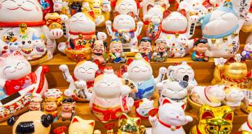 Group of Maneki Neko – lucky cat, common Japanese lucky charm, talisman which is often believed to bring good luck to the owner. They are usually made of ceramic or plastic.