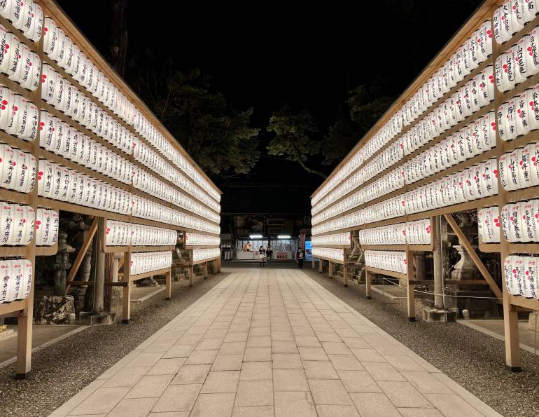 Illuminated lanterns lined up at Kitano Tenmangu Shrine, Kyoto