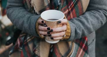 A pair of hands holding a cup of Mulled Wine
