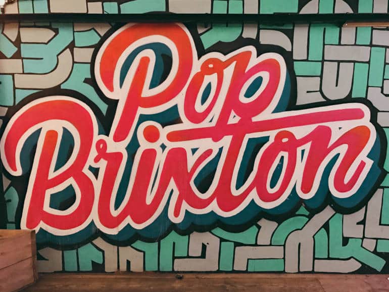 A graffiti style sign for a venue