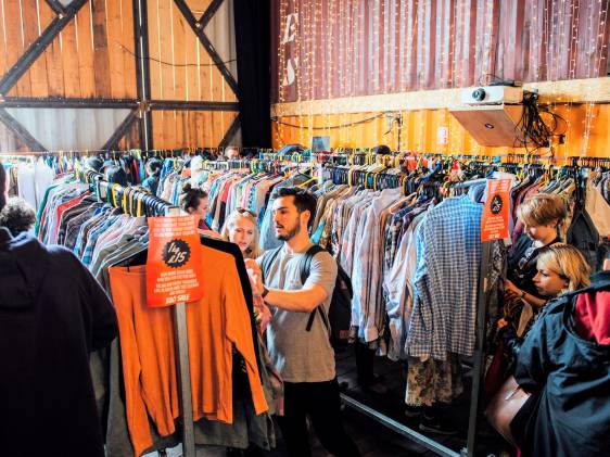 Man shopping for second hand clothes at Brixton Village Kilo Sake