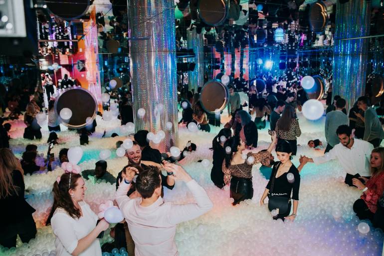 Ballie Ballerson party, people playing in a room filled with lots of balls