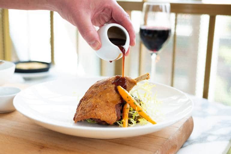 Aster chicken dish with wine glass