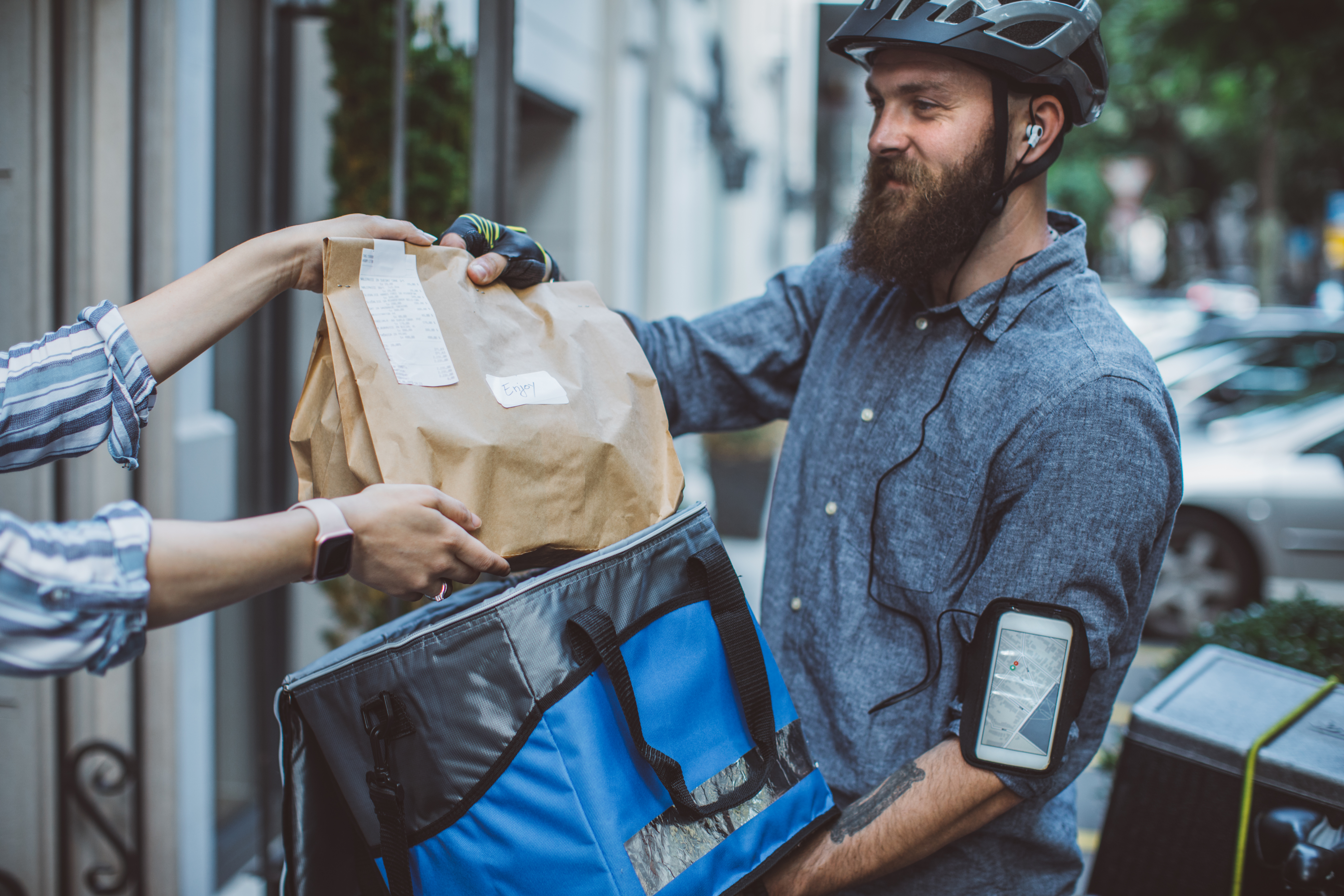 Bicycle delivery commuter with road bicycle delivering package to customer